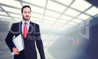 Composite image of handsome businessman holding briefcase and la