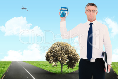 Composite image of businessman showing calculator while holding