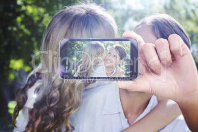 Composite image of hand holding smartphone showing