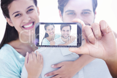 Composite image of hand holding smartphone showing