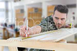 Composite image of worker marking on wooden plank