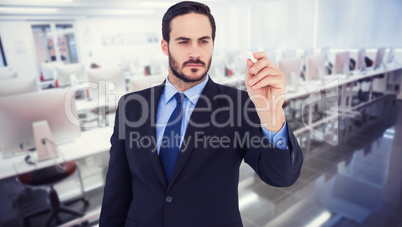 Composite image of businessman holding a chalk and writing somet