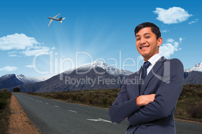 Composite image of smiling asian businessman with arms crossed