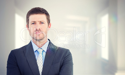 Composite image of businessman looking at the camera