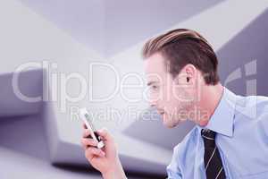 Composite image of businessman looking at phone