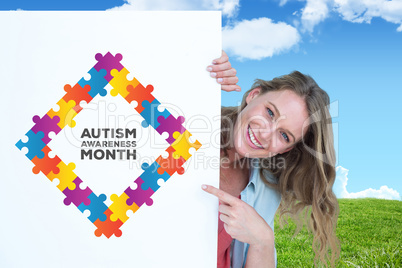 Composite image of woman holding poster