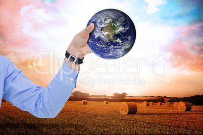 Composite image of businessman holding hand out in presentation