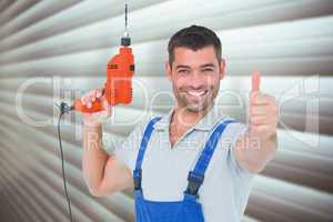 Composite image of smiling repairman with drill machine gesturin