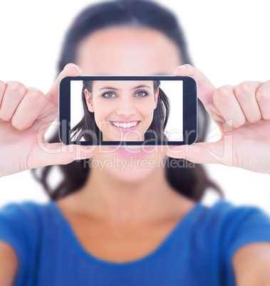 Composite image of pretty brunette smiling at camera