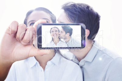 Composite image of hand holding smartphone showing