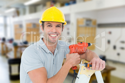 Composite image of happy technician holding drill machine while