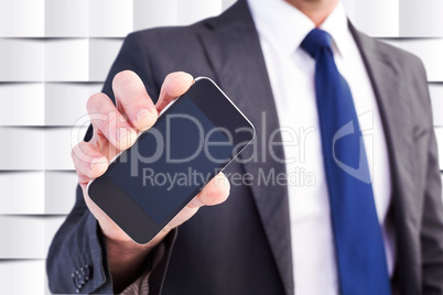 Composite image of businessman showing his smartphone screen