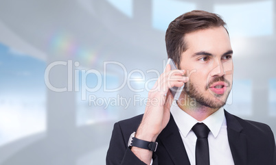 Composite image of smart businessman speaking on the phone