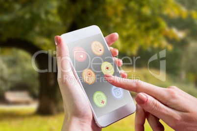 Composite image of hand holding smartphone