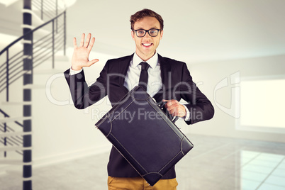 Composite image of young geeky businessman holding briefcase