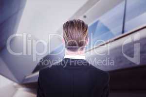 Composite image of rear view of elegant businessman in suit posi