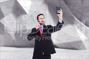 Composite image of businessman holding calculator while talking