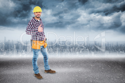 Composite image of smiling handyman gesturing thumbs up