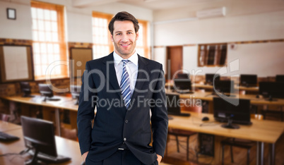 Composite image of smiling businessman standing with hands in po