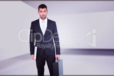 Composite image of businessman standing with his briefcase and d