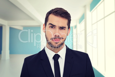 Composite image of portrait of a skeptical businessman well dres