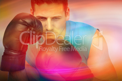 Composite image of close-up of a determined male boxer focused o