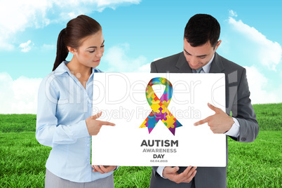 Composite image of business partners pointing at sign they are p