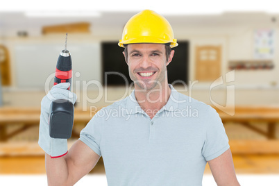 Composite image of confident carpenter holding cordless drill ma