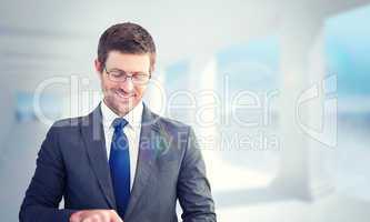 Composite image of businessman using his tablet pc