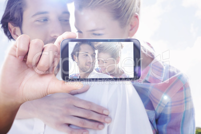 Composite image of hand holding smartphone showing