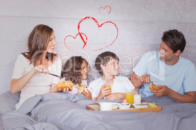 Composite image of family having breakfast in bed