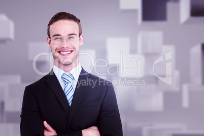 Composite image of smiling businessman in suit with arms crossed