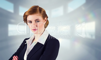 Composite image of stylish redhead businesswoman in suit