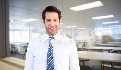 Composite image of smiling businessman standing with hands in po