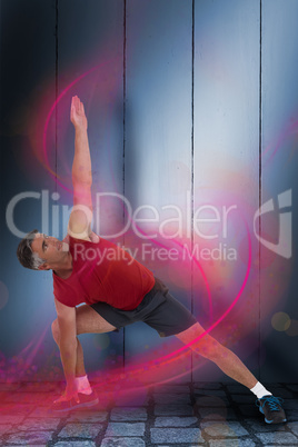 Composite image of fit man stretching his legs and arms