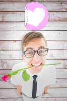 Composite image of geeky hipster holding a red rose in his teeth