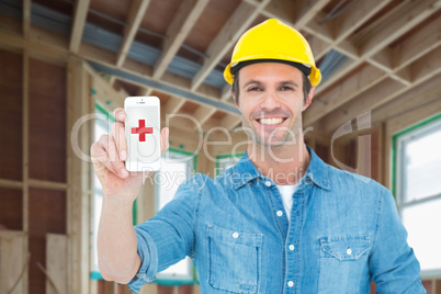 Composite image of happy carpenter showing smart phone