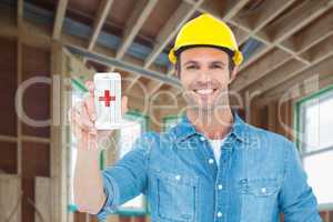 Composite image of happy carpenter showing smart phone