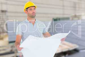 Composite image of thoughtful male architect holding blueprint