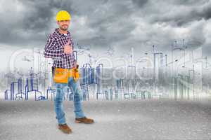 Composite image of smiling handyman gesturing thumbs up