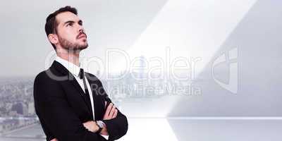 Composite image of thinking businessman with his arms crossed