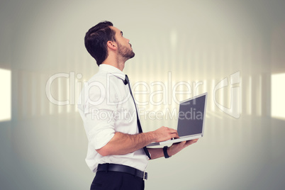Composite image of sophisticated businessman standing using a la
