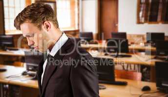 Composite image of young handsome businessman looking down