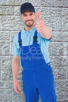 Composite image of repairman gesturing thumbs up