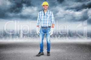 Composite image of full length portrait of confident handyman