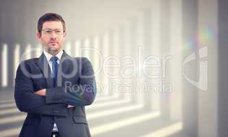 Composite image of frowning businessman looking at camera