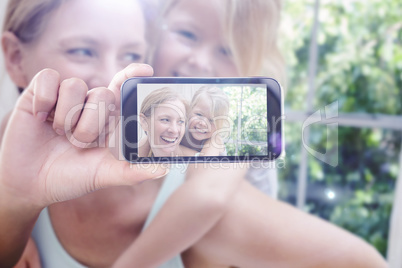 Composite image of hand holding smartphone showing