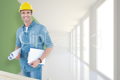 Composite image of happy carpenter holding rolled blueprint and