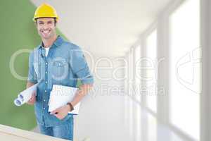 Composite image of happy carpenter holding rolled blueprint and