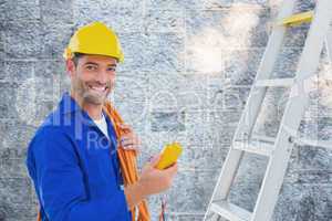 Composite image of smiling male electrician holding multimeter i